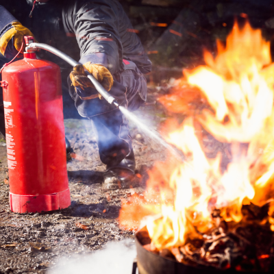 A person putting out a fire in training.